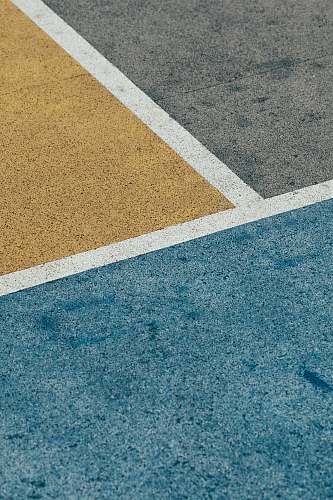hong kong closeup gray, yellow, and blue painted pavement minimal